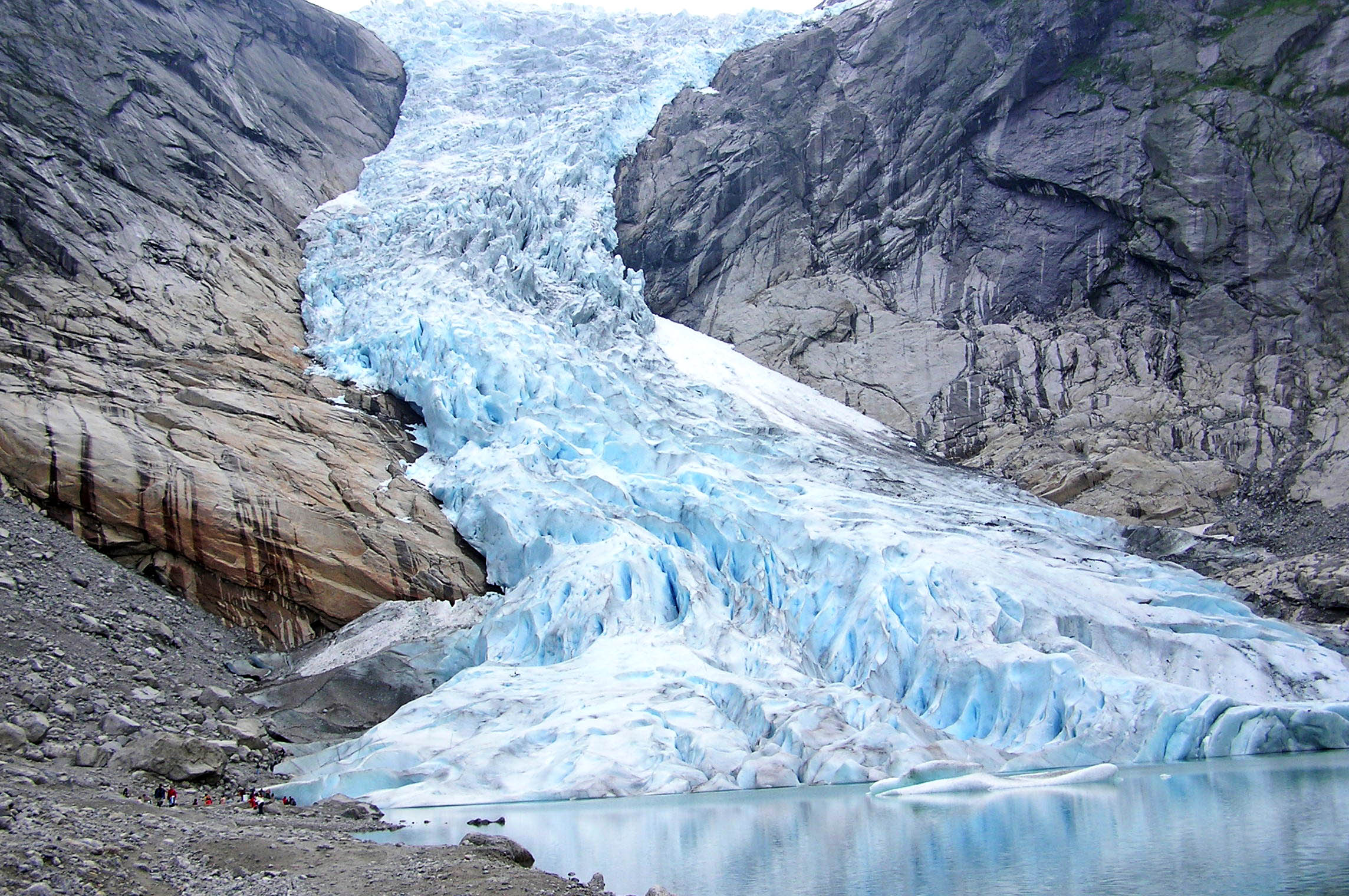 La imagen muestra un glaciar de hielo descendiendo por una montaña